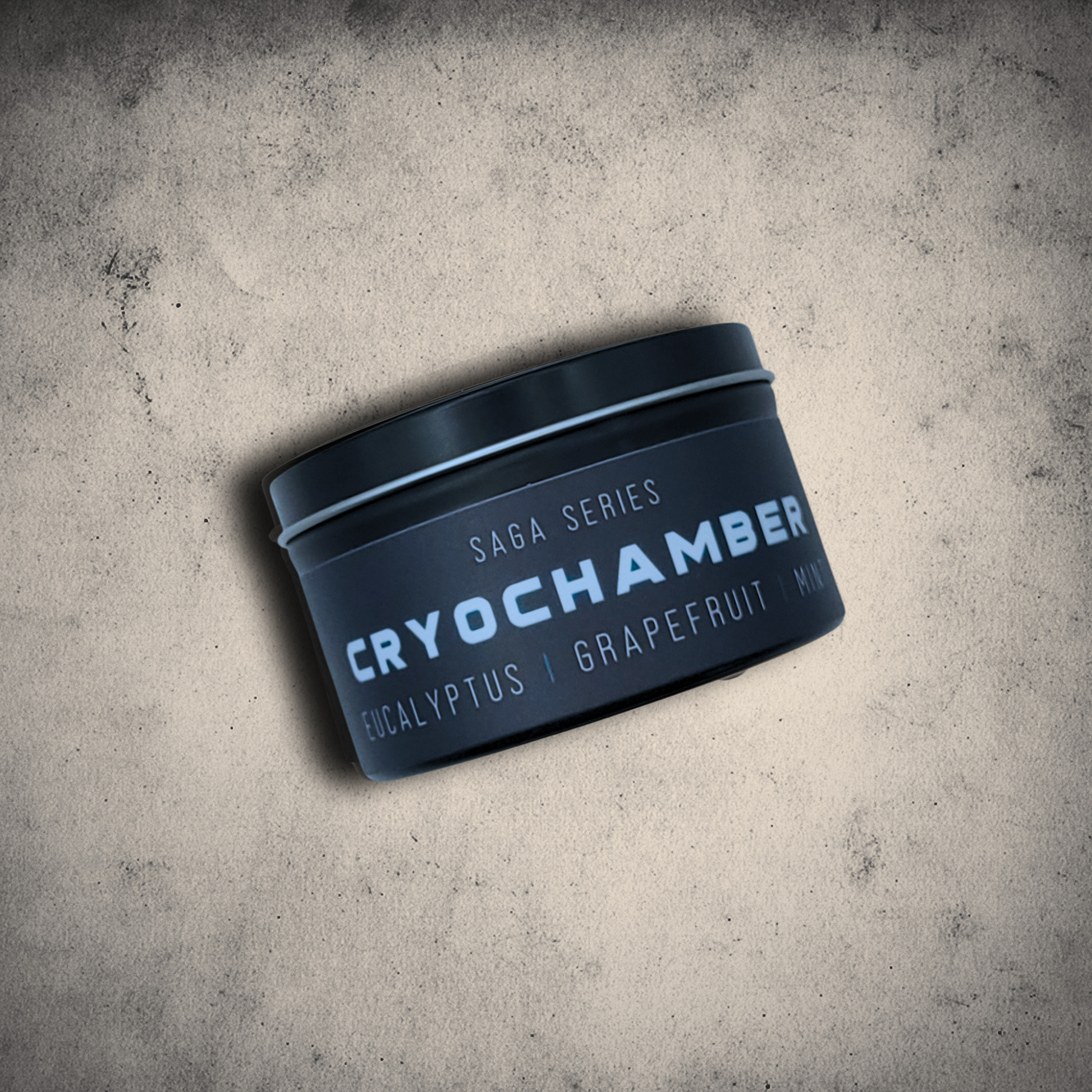 Emberlight Archives Cryochamber candle in an 8oz black tin with black label against a gray stone background, Grapefruit Mint scent.
