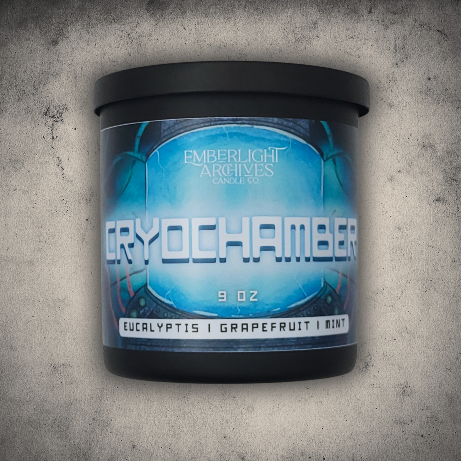 Emberlight Archives Cryochamber candle in a 9oz black glass jar with illustrated sci-fi label against a gray stone background, Grapefruit Mint scent.