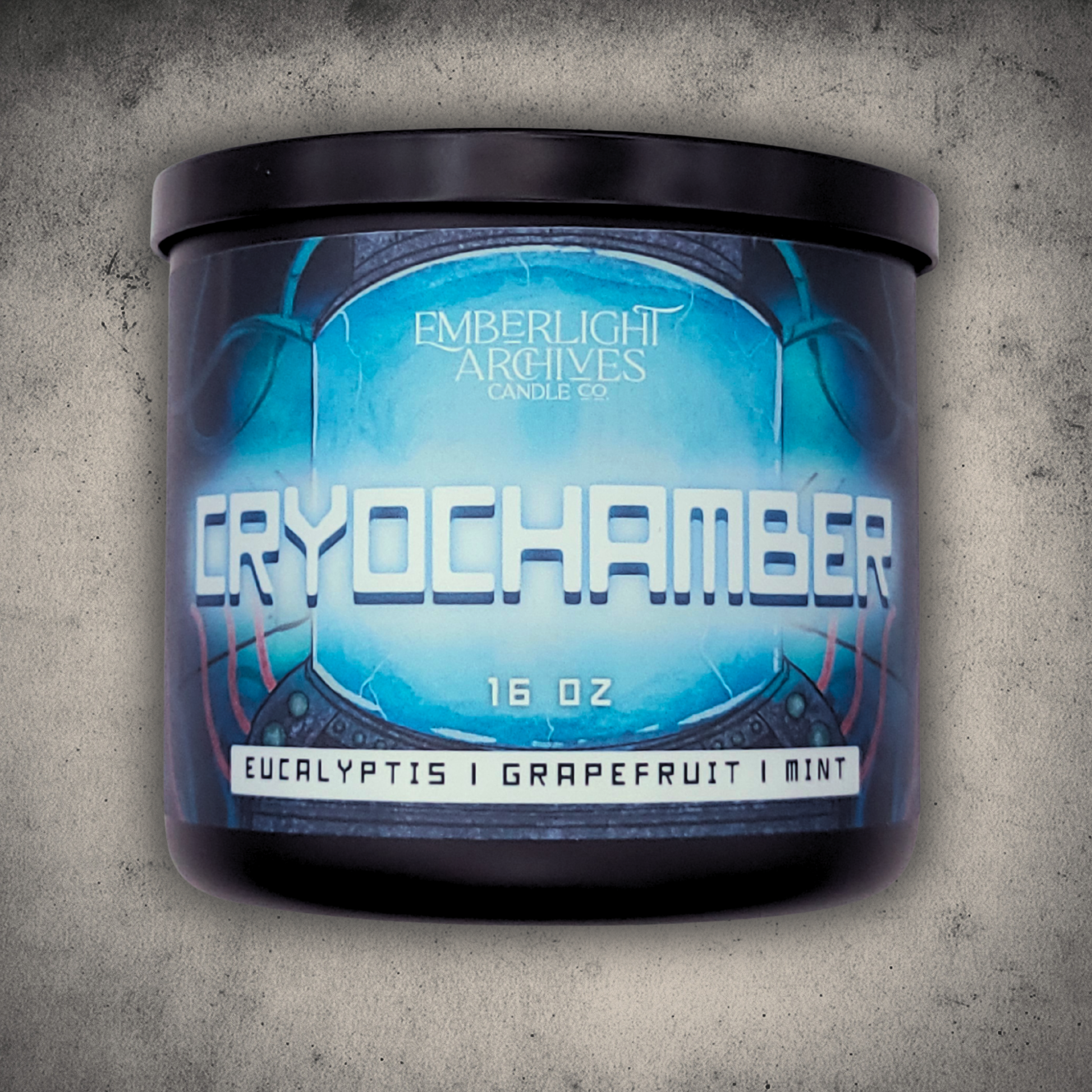 Emberlight Archives Cryochamber candle in a 16oz black glass jar with illustrated sci-fi label against a gray stone background, Grapefruit Mint scent.