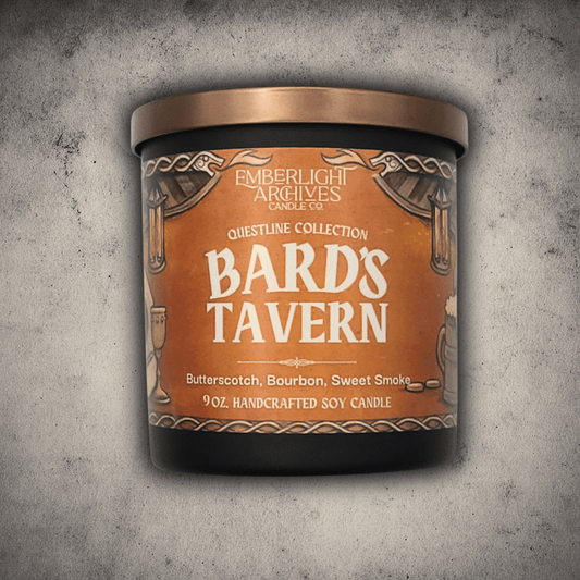 Emberlight Archives Bard's Tavern candle in a 9oz black glass jar with illustrated rustic tavern label against a gray stone background, Butterscotch and Bourbon scent.