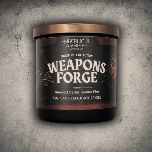 Emberlight Archives Weapon's Forge candle in a 9oz black glass jar with illustrated blacksmith label against a gray stone background, Amber and Cedar scent.