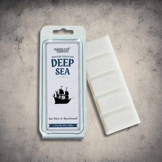 Emberlight Archives Deep Sea wax melt bar with a blue label against a gray stone background, Sea Mist and Beachwood scent.