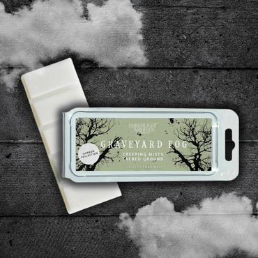 Emberlight Archives Graveyard Fog wax melt bar with a pale green label against a dark wood background with a mist effect.