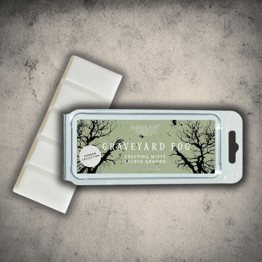 Emberlight Archives Graveyard Fog wax melt bar with a pale green label against a gray stone background.