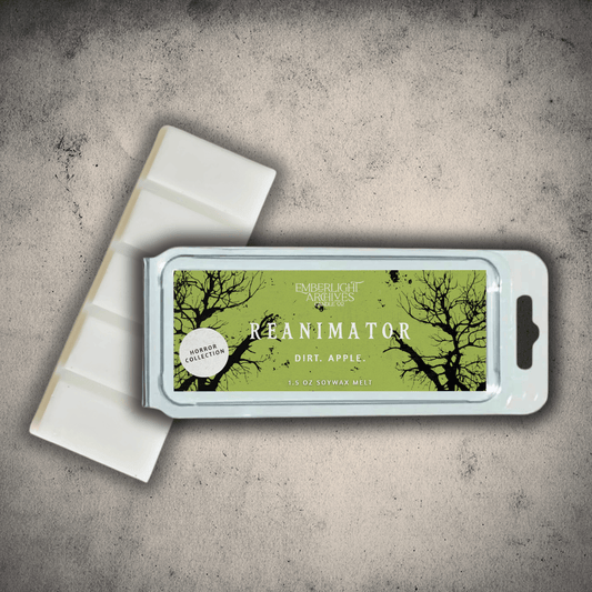 Emberlight Archives Reanimator wax melt bar with a bright green label against a gray stone background, Dirt and Apple scent.