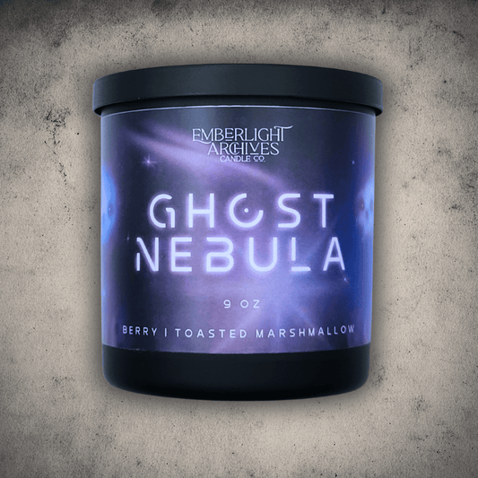 Emberlight Archives Ghost Nebula candle in a 9oz black glass jar with illustrated nebula label against a gray stone background, Berry and Marshmallow scent.