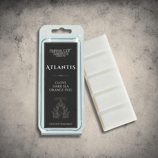 Emberlight Archives Atlantis wax melt bar with a black label against a gray stone background, Clove & Orange Peel scent.