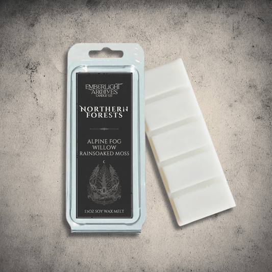 Emberlight Archives Northern Forests wax melt bar with a black label against a gray stone background, Rain & Moss scent.