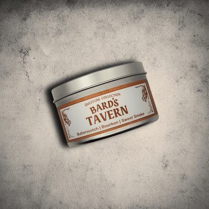 Emberlight Archives Bard's Tavern candle in an 8oz silver tin against a gray stone background, Butterscotch and Bourbon scent.