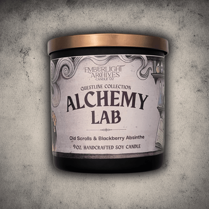 Emberlight Archives Alchemy Lab candle in a 9oz black glass jar with illustrated scrolls and potions label against a gray stone background, Old Scrolls and Blackberry Absinthe scent.