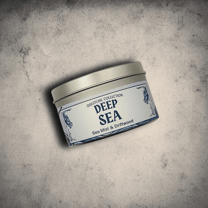 Emberlight Archives Deep Sea candle in an 8oz tin against a gray stone background, Sea Mist and driftwood scent.
