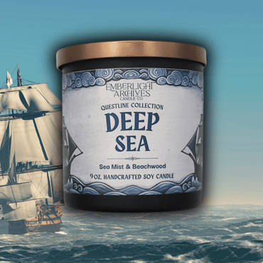 Emberlight Archives Deep Sea candle  in a black jar with illustrated sailing ship label against an ocean background, Sea Mist and Beachwood scent.