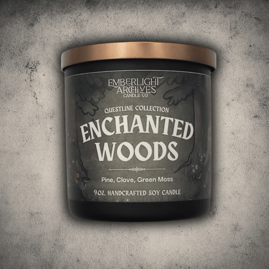 Emberlight Archives Enchanted Woods candle in a 9oz black glass jar with illustrated forest label against a gray stone background, Pine and Clove scent.