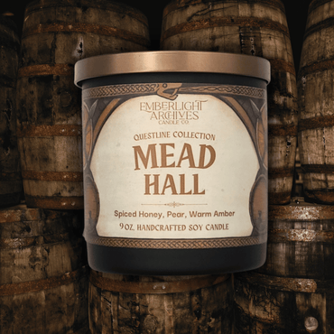 Emberlight Archives Mead Hall candle in a black glass jar with illustrated label against a mead barrels background, Pear and Spiced Honey scent.