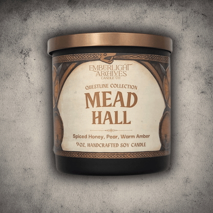 9oz Mead Hall candle in a 9oz black glass jar with illustrated label against a gray stone background, Pear and Spiced Honey scent.