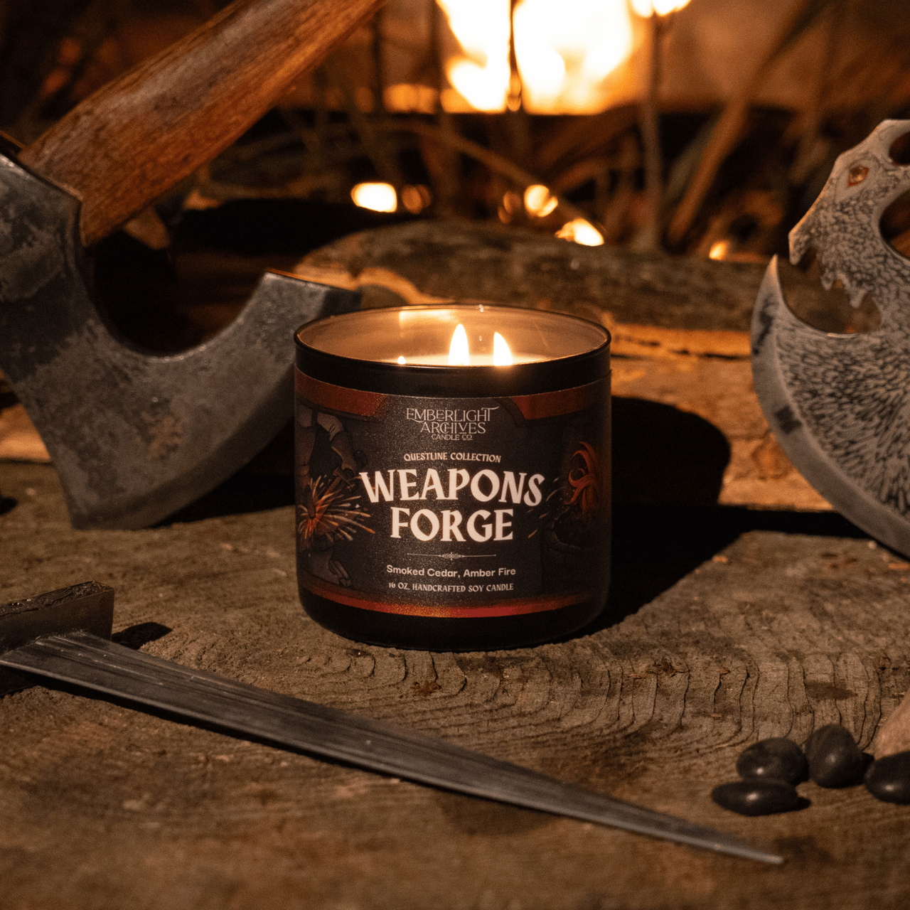 16oz candle labeled 'Weapons Forge' on a rustic background with tools and fire.