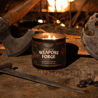 16oz candle labeled 'Weapons Forge' on a rustic background with tools and fire.