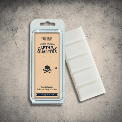 Emberlight Archives Captain's Quarters wax melt bar with a tan label against a gray stone background, Tobacco and Sandalwood scent.