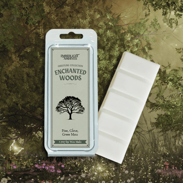 Enchanted Woods wax melt bar by Emberlight Archives with a green label against a forest background, Pine and Clove scent.