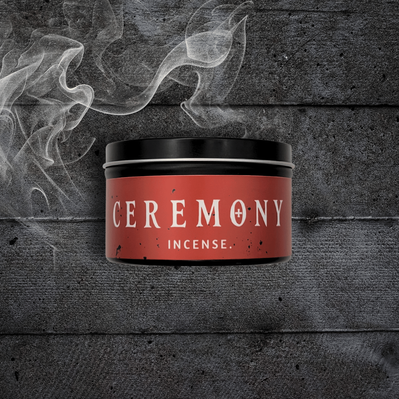 8oz Ceremony candle by Emberlight Archives in a black tin with red label against a dark wood background, Incense scent.