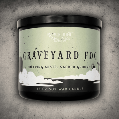 16oz candle in a black jar labeled 'Graveyard Fog' by Emberlight Archives on a textured gray background