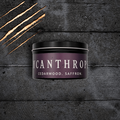 Lycanthrope horror candle by Emberlight Archives – 8oz black tin  with purple label against a dark background, Cedarwood & Saffron scent.