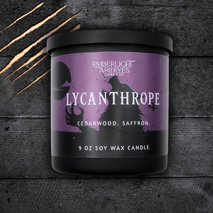 Lycanthrope horror candle by Emberlight Archives – 9oz black glass jar with purple werewolf label against a dark background, Cedarwood & Saffron scent.