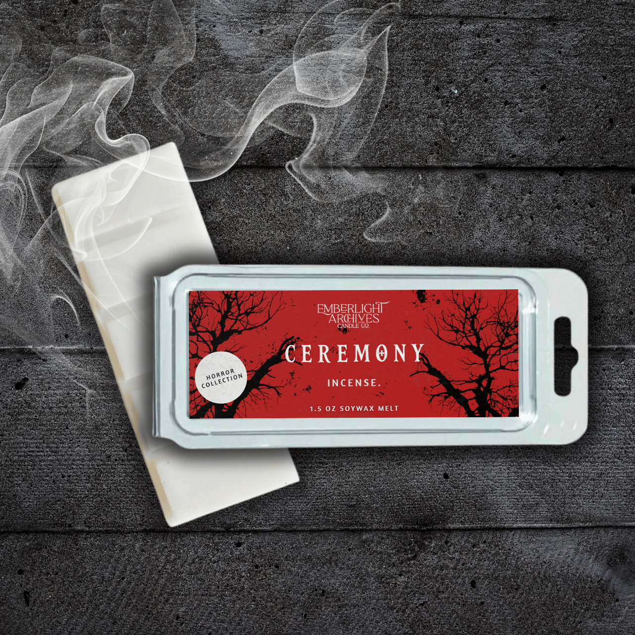 Ceremony wax melt bar by Emberlight Archives with a red label against a dark wood background and smoke, Incense scent.