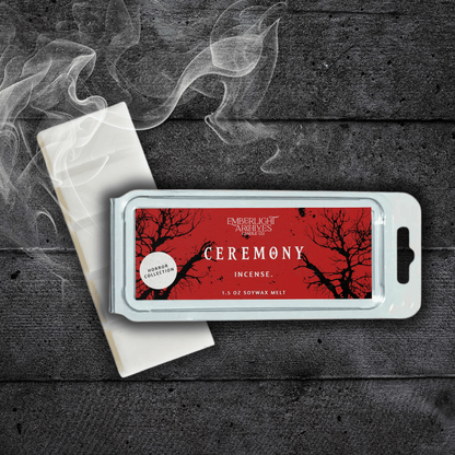 Ceremony wax melt bar by Emberlight Archives with a red label against a dark wood background and smoke, Incense scent.