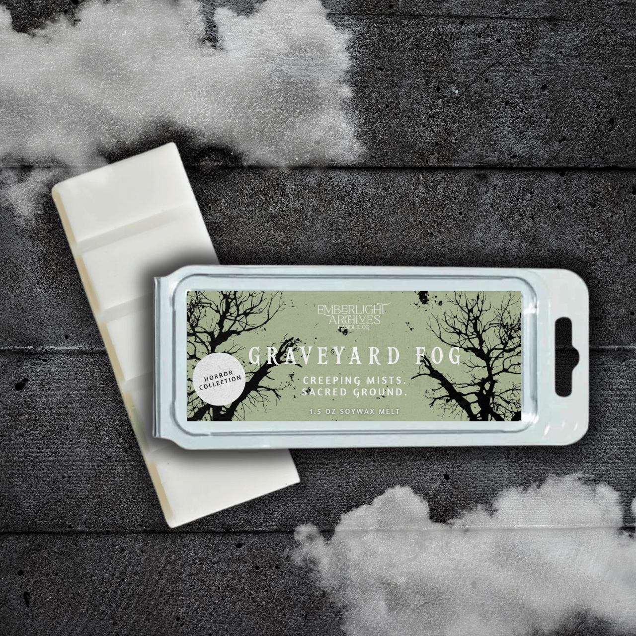 Emberlight Archives Graveyard Fog wax melt bar with a pale green label against a dark wood background with a mist effect.