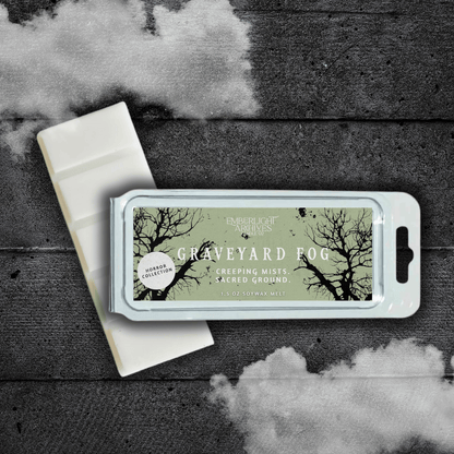 Emberlight Archives Graveyard Fog wax melt bar with a pale green label against a dark wood background with a mist effect.