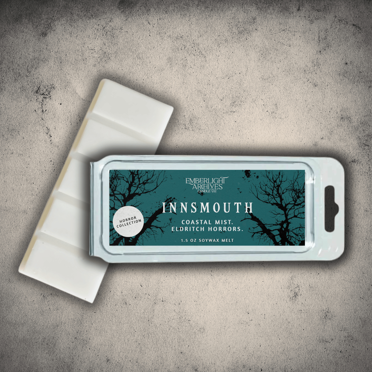 Emberlight Archives Innsmouth wax melt bar with a blue label against a gray stone background.