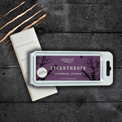 Lycanthrope wax melt bar by Emberlight Archives with a purple label against a dark wood background, Cedarwood and Saffron scent.