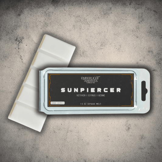 Emberlight Archives Sunpiercer wax melt bar with a black label against a gray stone background, Citrus scent.