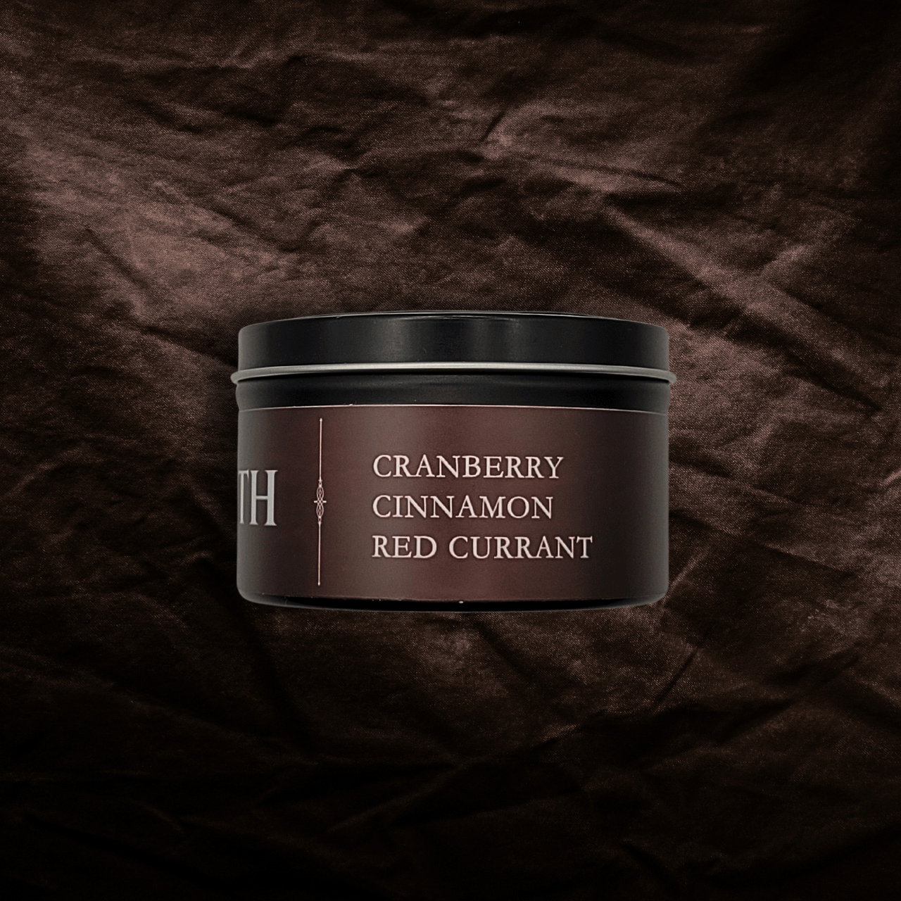 Dark red container with 'Cranberry Cinnamon Red Currant' text on a textured red background