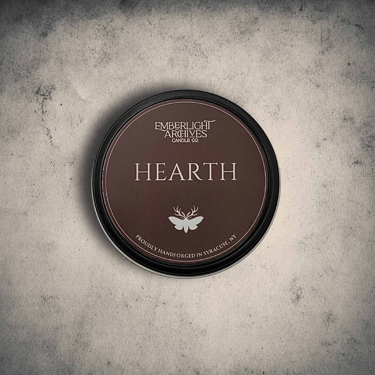 Hearth candle tin lid 8oz on gray background.