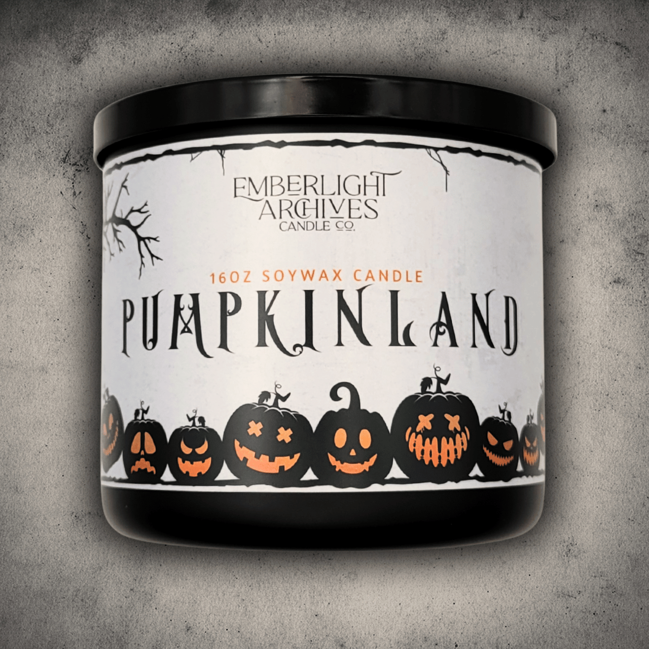 Candle with 'Pumpkinland' label and Emberlight Archives branding on a textured gray background