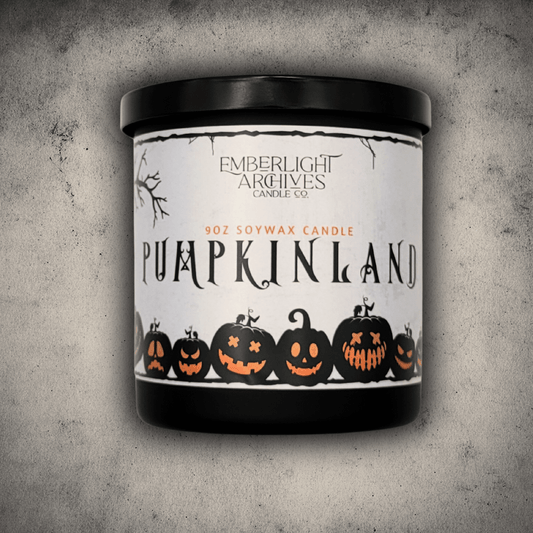 Emberlight Archives Pumpkinland candle in a 9oz black glass jar with pumpkin label against a gray stone background, Pumpkin Pie scent.
