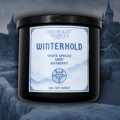16oz Winterhold candle by Emberlight Archives in a black glass jar with white label against a winter castle background, Spruce, Mint, and Bayberry scent.