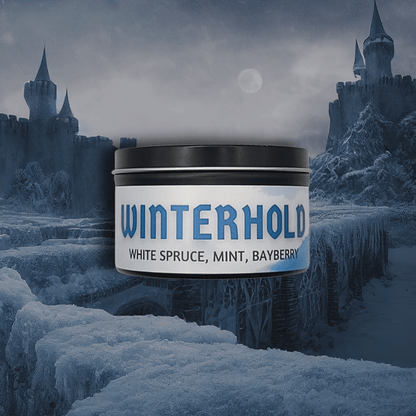8oz Winterhold candle by Emberlight Archives in a black tin with white label against a winter castle background, Spruce, Mint, and Bayberry scent.