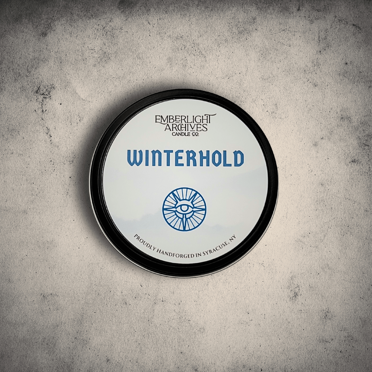 White Winterhold tin lid on gray stone background.