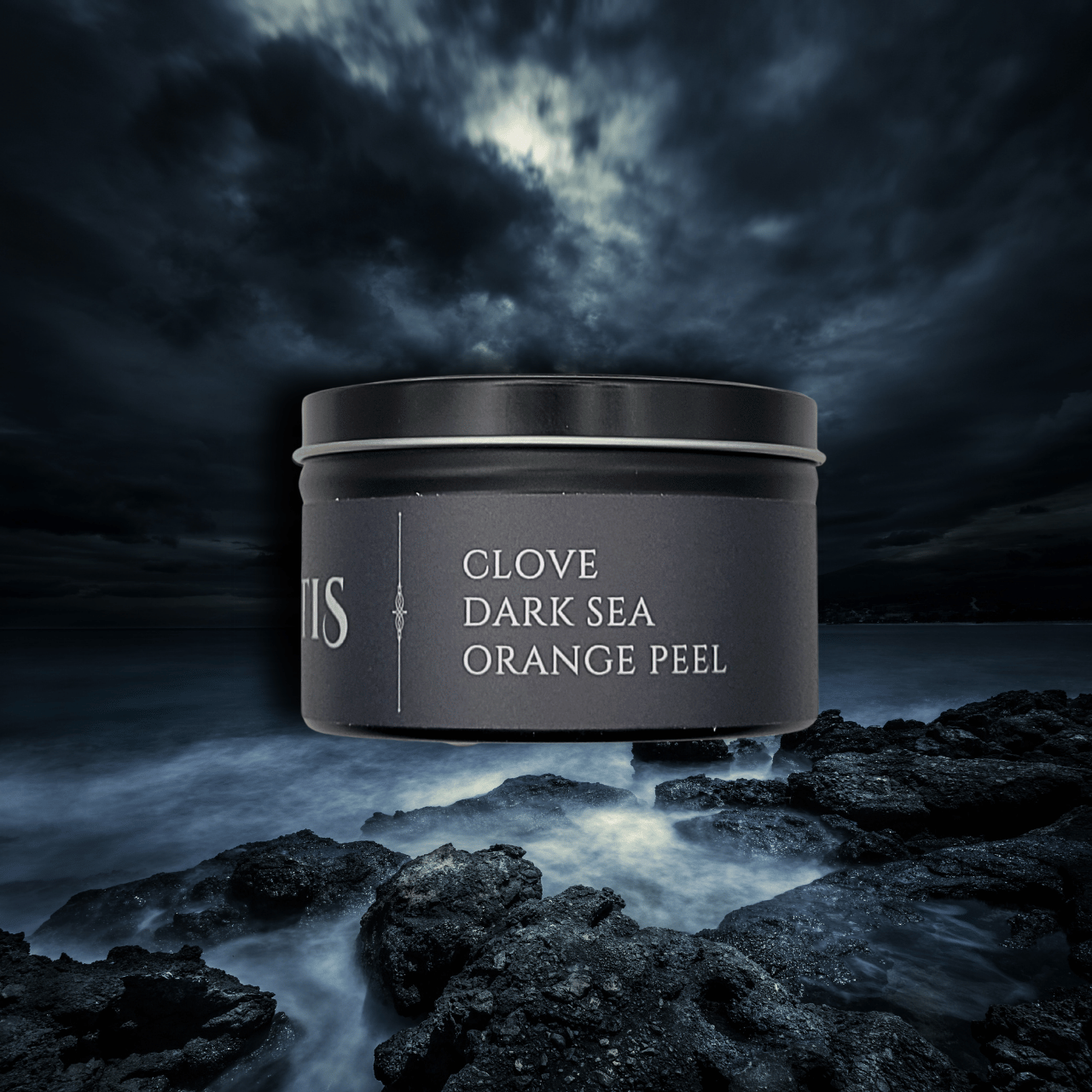 Atlantis candle tin showing 'Clove Dark Sea Orange Peel' on a dark, rocky landscape with a moody sky.