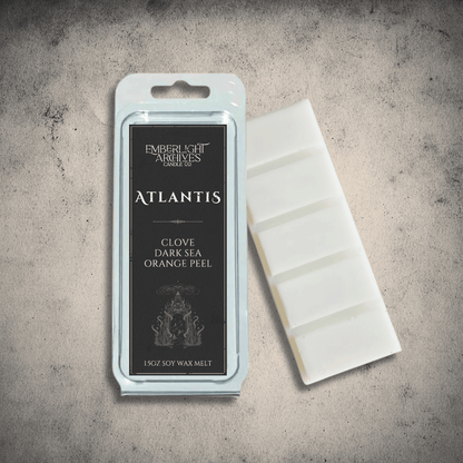 Emberlight Archives Atlantis wax melt bar with a black label against a gray stone background, Clove & Orange Peel scent.